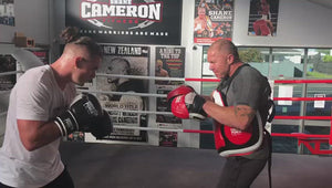 Joshua Francis doing pads with Shane Cameron